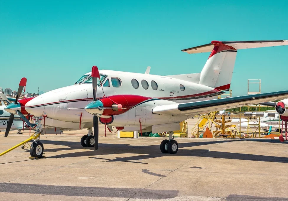 A small white airplane sitting on top of an airport runway.